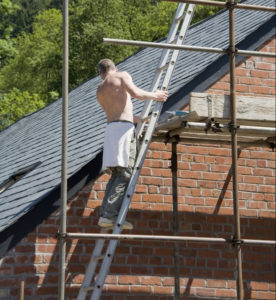 Man working on a roof near Worcester UK Worcestershire